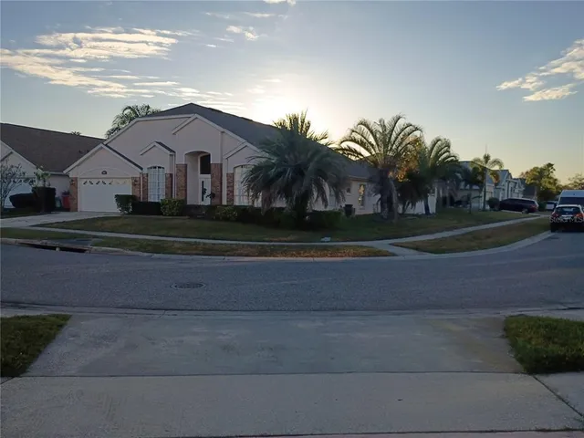 a front view of a house with a yard and trees
