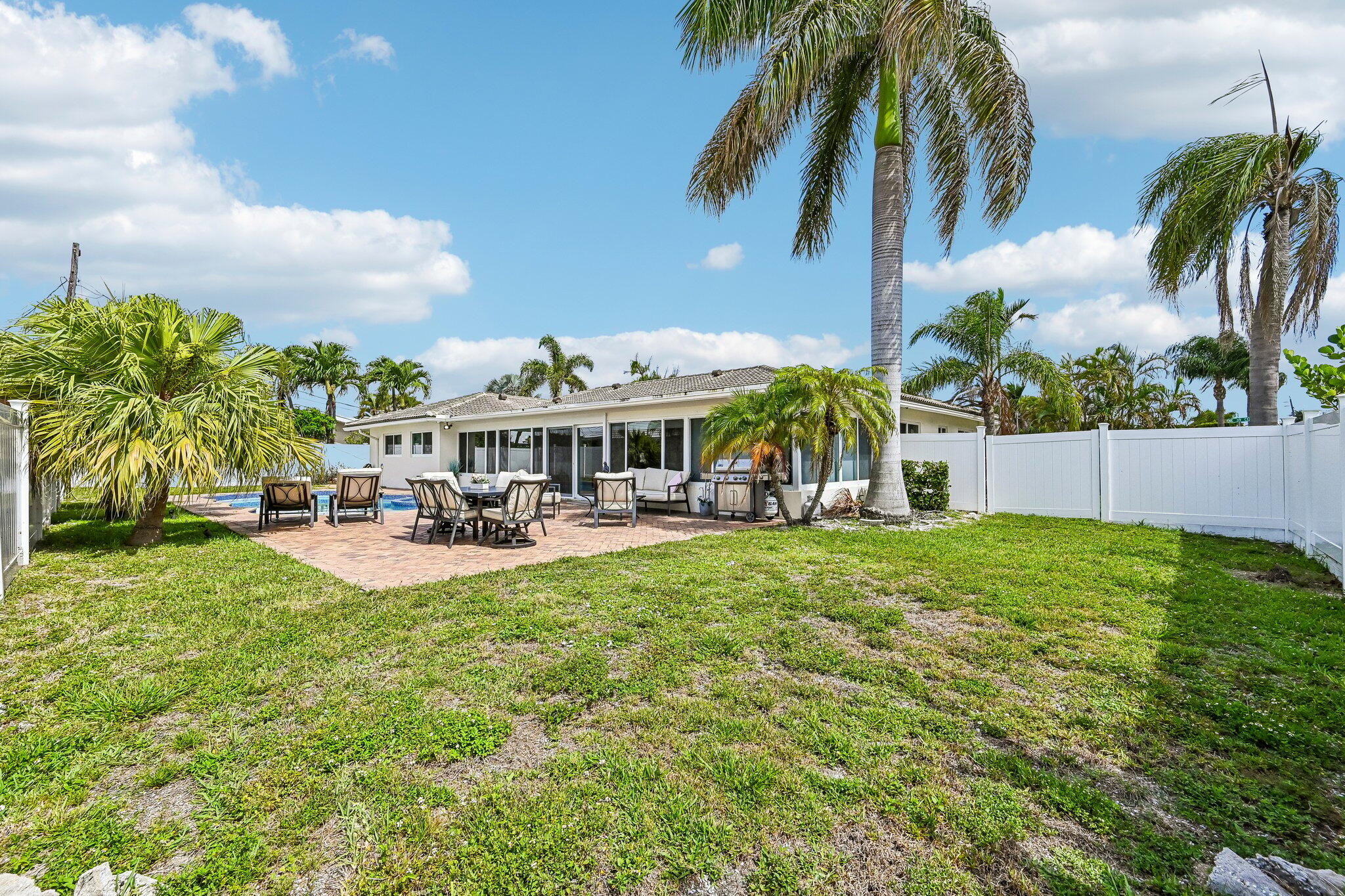 2940 Northeast 39th Court Lighthouse Point, FL 33064 - Photo 33 of 42 a front view of house with yard and outdoor seating
