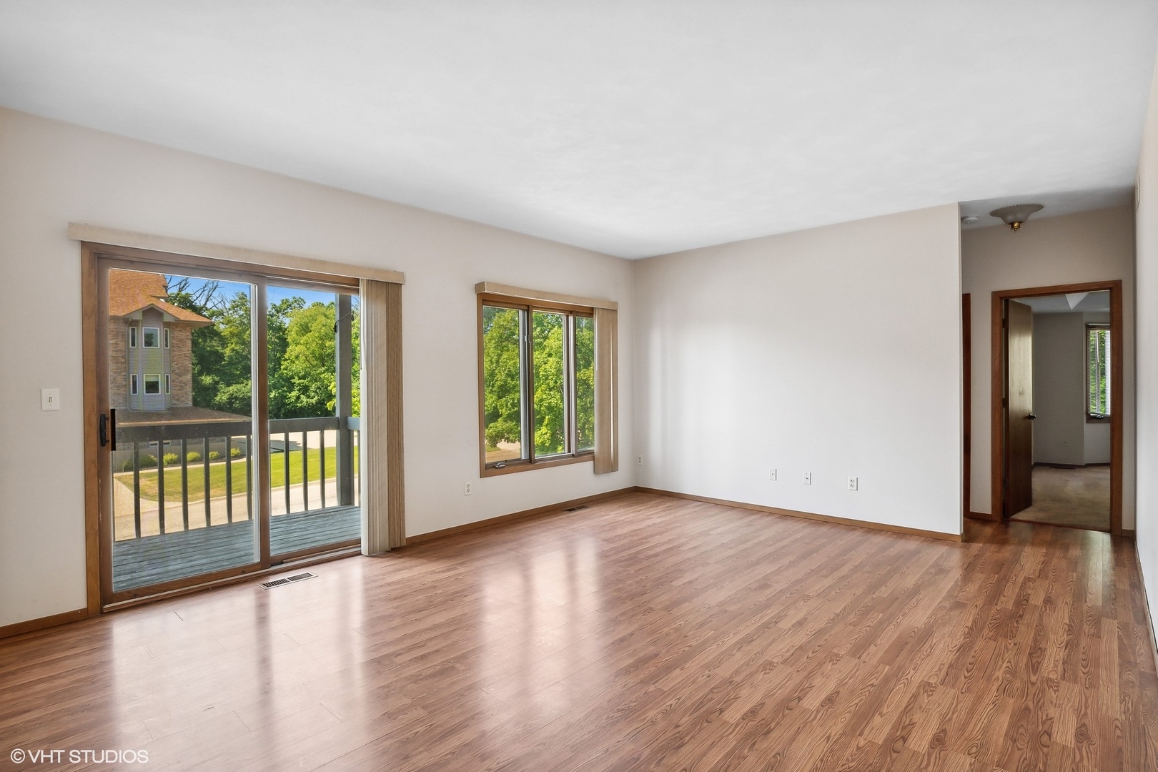 3108 Woodland Drive, Unit 3108 Zion, IL 60099 - Photo 2 of 15 an empty room with wooden floor and windows