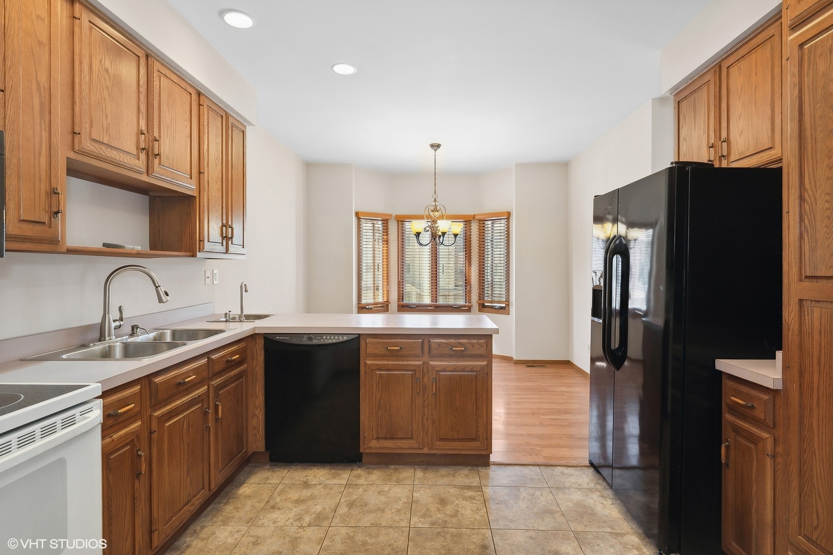3108 Woodland Drive, Unit 3108 Zion, IL 60099 - Photo 4 of 15 a kitchen with a sink stove and refrigerator