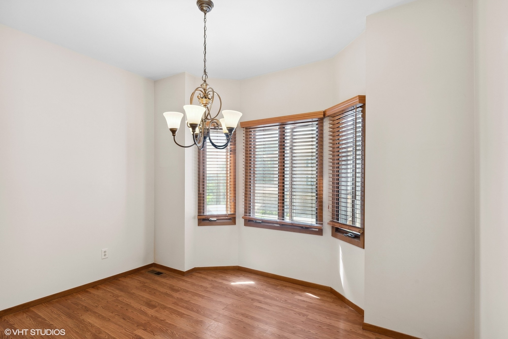 3108 Woodland Drive, Unit 3108 Zion, IL 60099 - Photo 5 of 15 a view of an empty room with wooden floor and windows