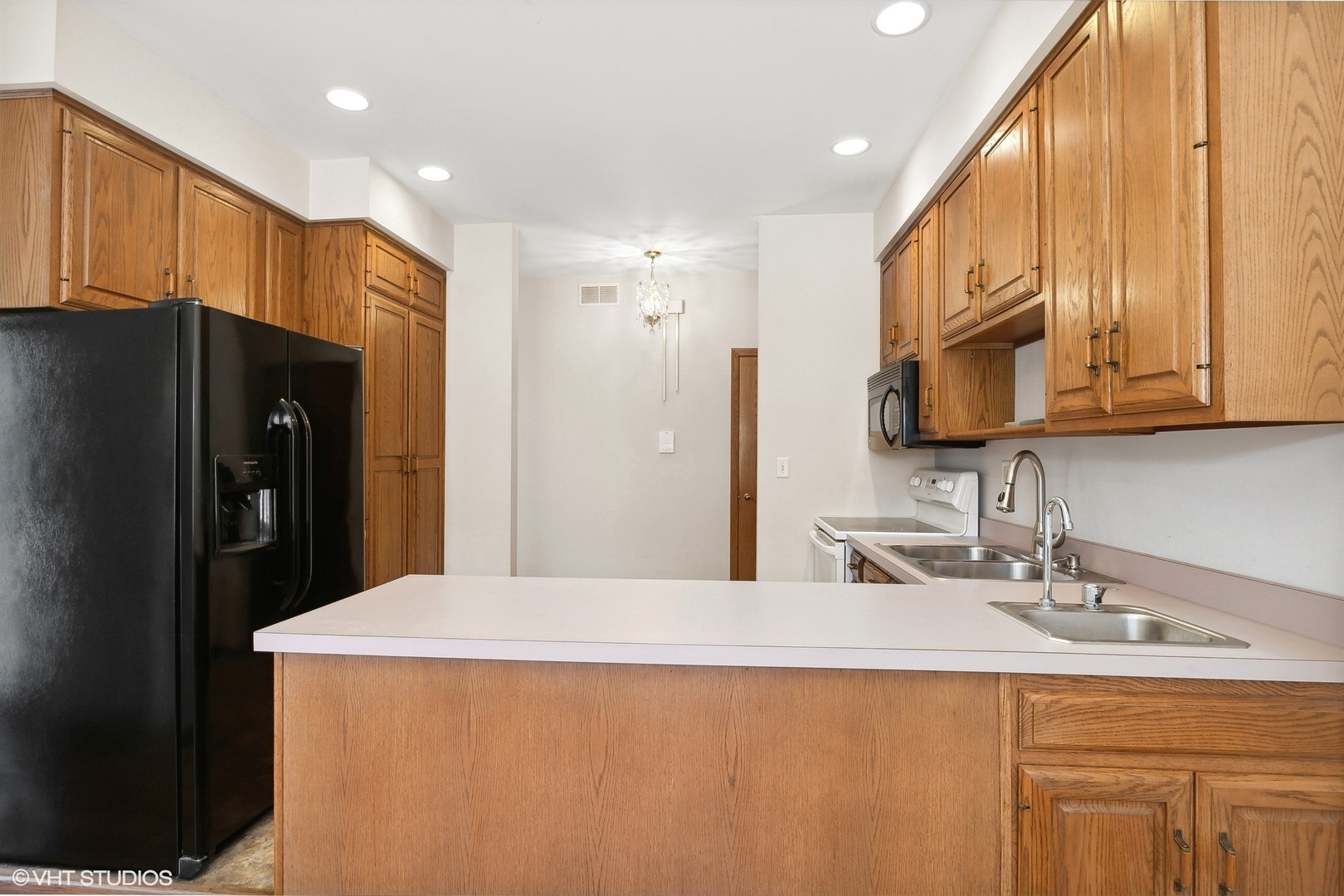 3108 Woodland Drive, Unit 3108 Zion, IL 60099 - Photo 6 of 15 a kitchen with stainless steel appliances a refrigerator sink and cabinets