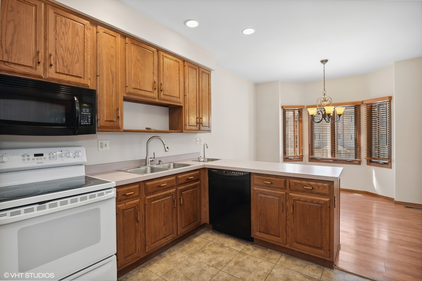 3108 Woodland Drive, Unit 3108 Zion, IL 60099 - Photo 7 of 15 a kitchen with a sink stove and microwave