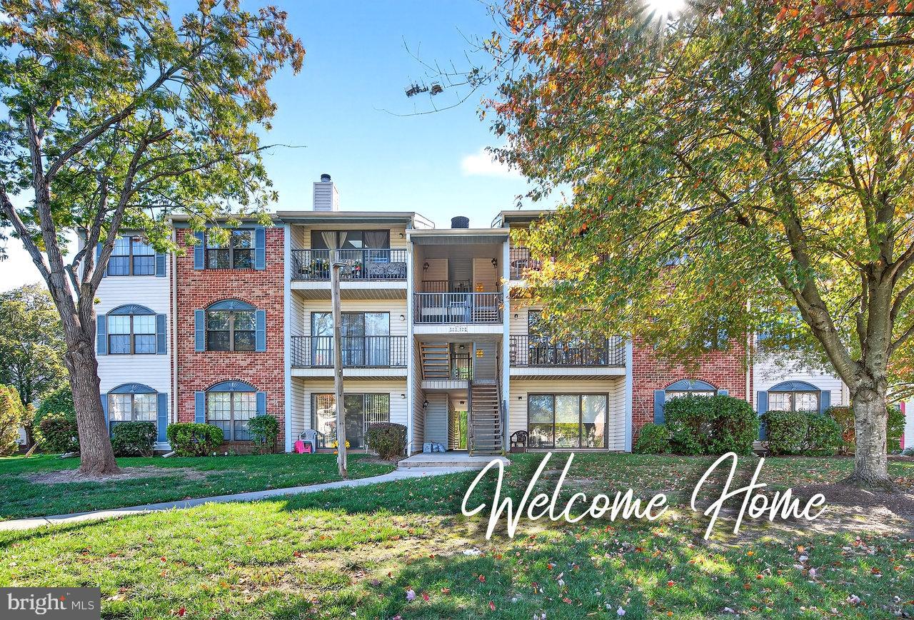front view of a brick house next to a yard