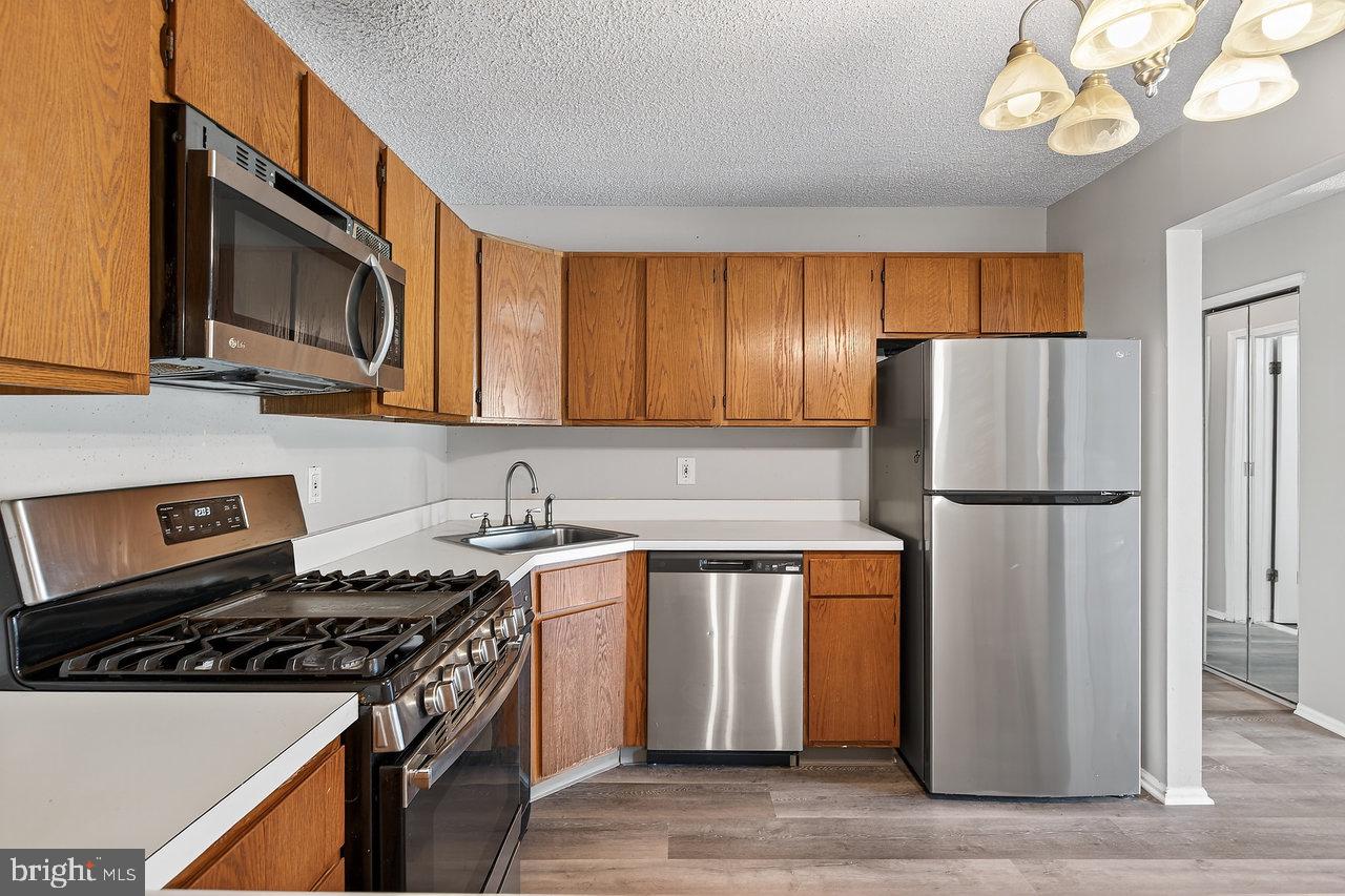 41 Rickard Court, Unit 41 Lawrenceville, NJ 08648 - Photo 4 of 15 a kitchen with stainless steel appliances granite countertop a sink stove and refrigerator