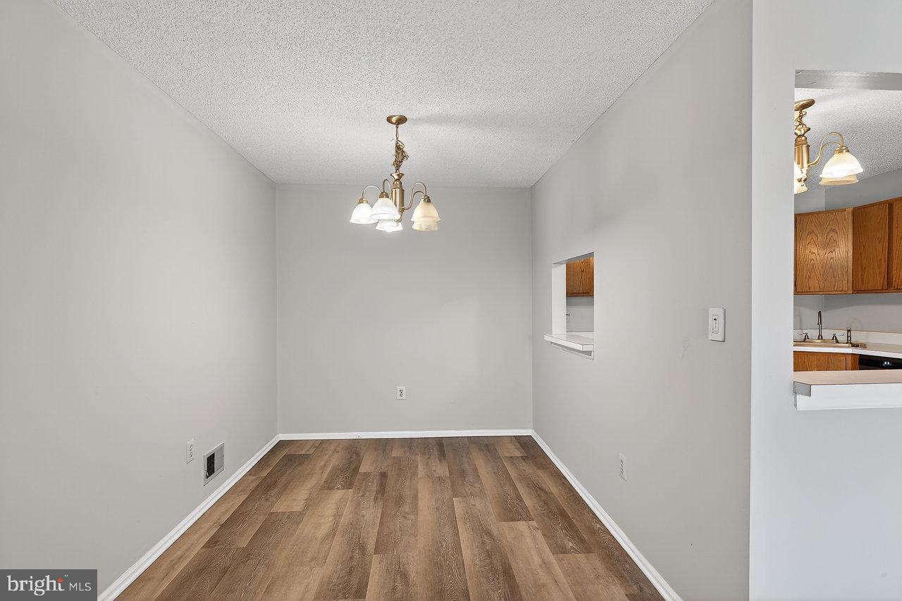 41 Rickard Court, Unit 41 Lawrenceville, NJ 08648 - Photo 5 of 15 a view of empty room with wooden floor