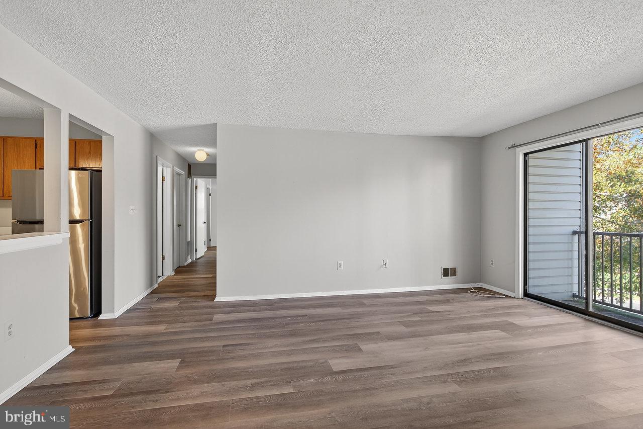 41 Rickard Court, Unit 41 Lawrenceville, NJ 08648 - Photo 6 of 15 a view of an empty room with wooden floor and a window