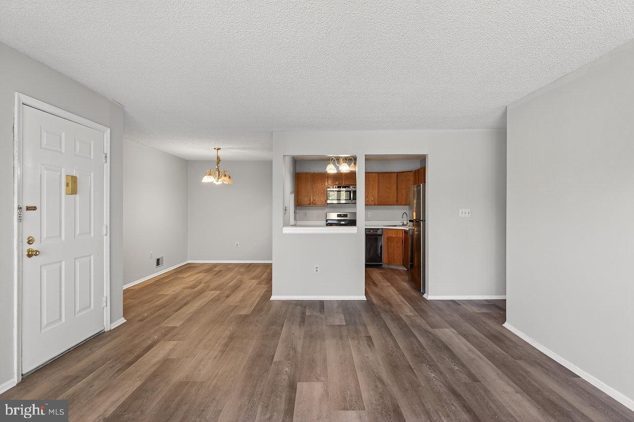 41 Rickard Court, Unit 41 Lawrenceville, NJ 08648 - Photo 7 of 15 a view of a kitchen with wooden floor and a refrigerator