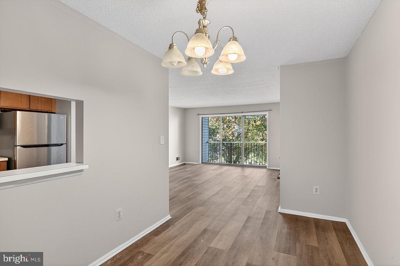 41 Rickard Court, Unit 41 Lawrenceville, NJ 08648 - Photo 8 of 15 an empty room with wooden floor and windows