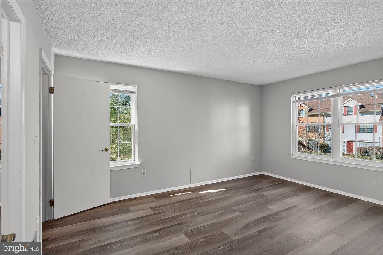 41 Rickard Court, Unit 41 Lawrenceville, NJ 08648 - Photo 9 of 15 a view of an empty room with wooden floor and a window