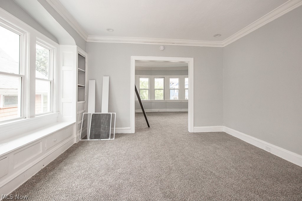 1000 Eddy Road Cleveland, OH 44108 - Photo 26 of 38 Spare room featuring light carpet and ornamental molding