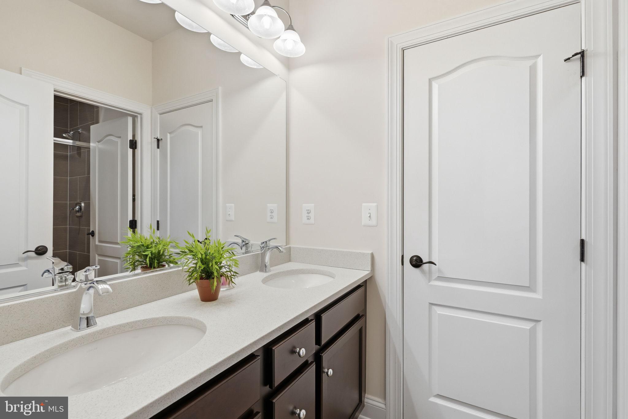 7821 Old Falls Road McLean, VA 22102 - Photo 34 of 62 a bathroom with a sink and a mirror