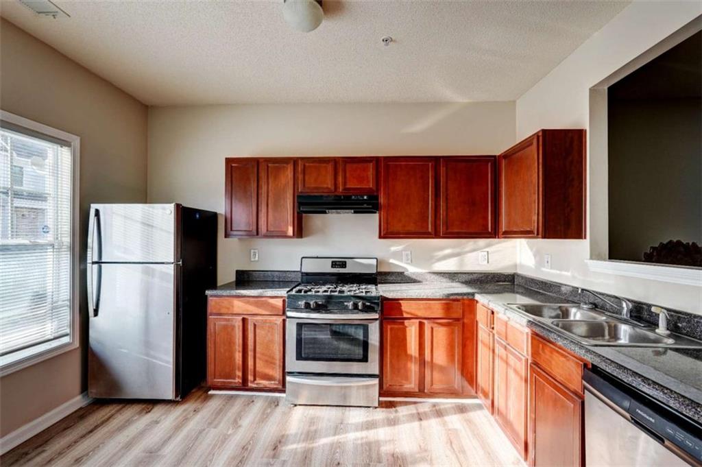 2837 Laurel Ridge Circle East Point, GA 30344 - Photo 3 of 11 a kitchen with stainless steel appliances granite countertop a stove a refrigerator and a stove