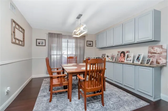 a kitchen with stainless steel appliances a stove a refrigerator and wooden floor
