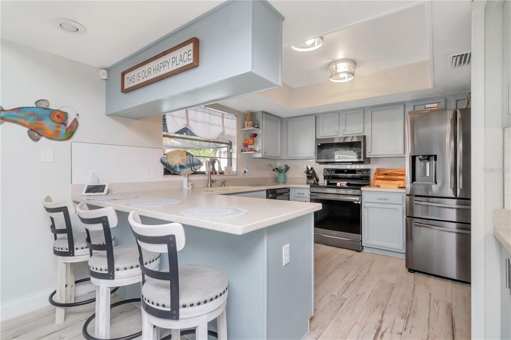 2604 Goldcrest Place Valrico, FL 33596 - Photo 13 of 72 a kitchen with granite countertop stainless steel appliances a sink a counter top space and cabinets