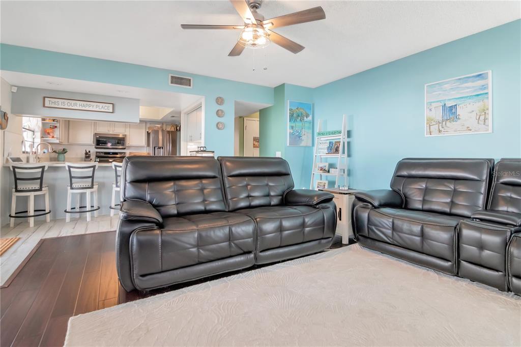 2604 Goldcrest Place Valrico, FL 33596 - Photo 16 of 72 a living room with furniture and a chandelier
