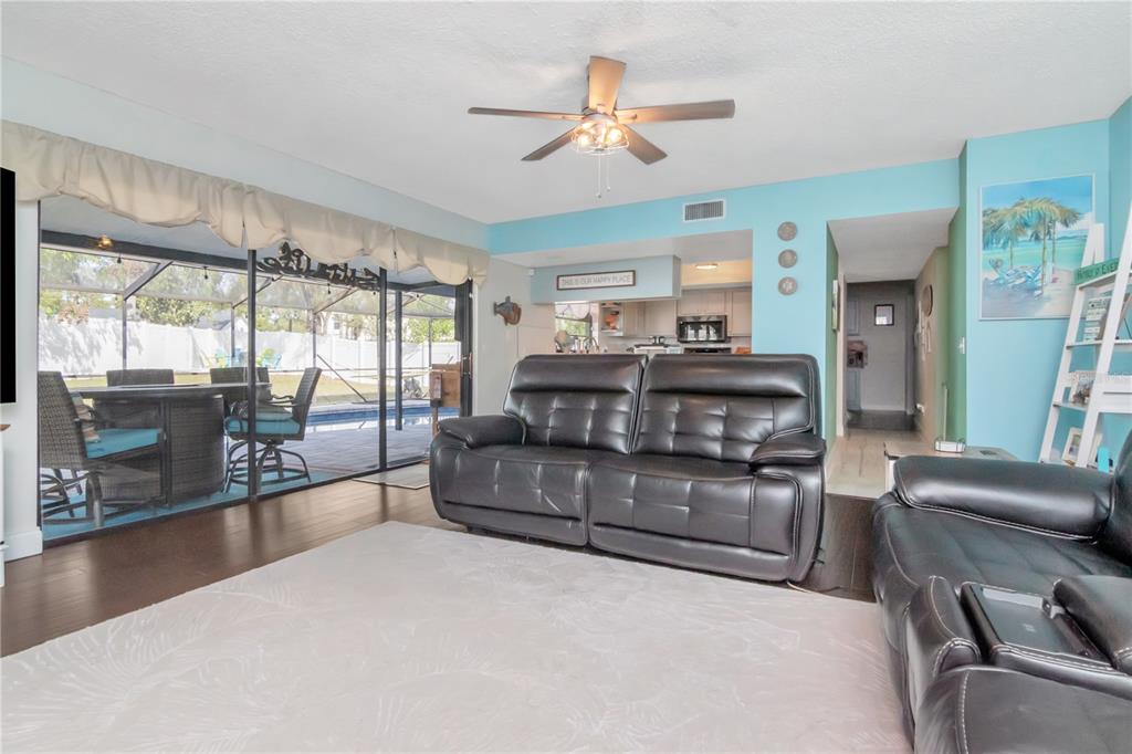 2604 Goldcrest Place Valrico, FL 33596 - Photo 17 of 72 a living room with furniture and a large window with kitchen view