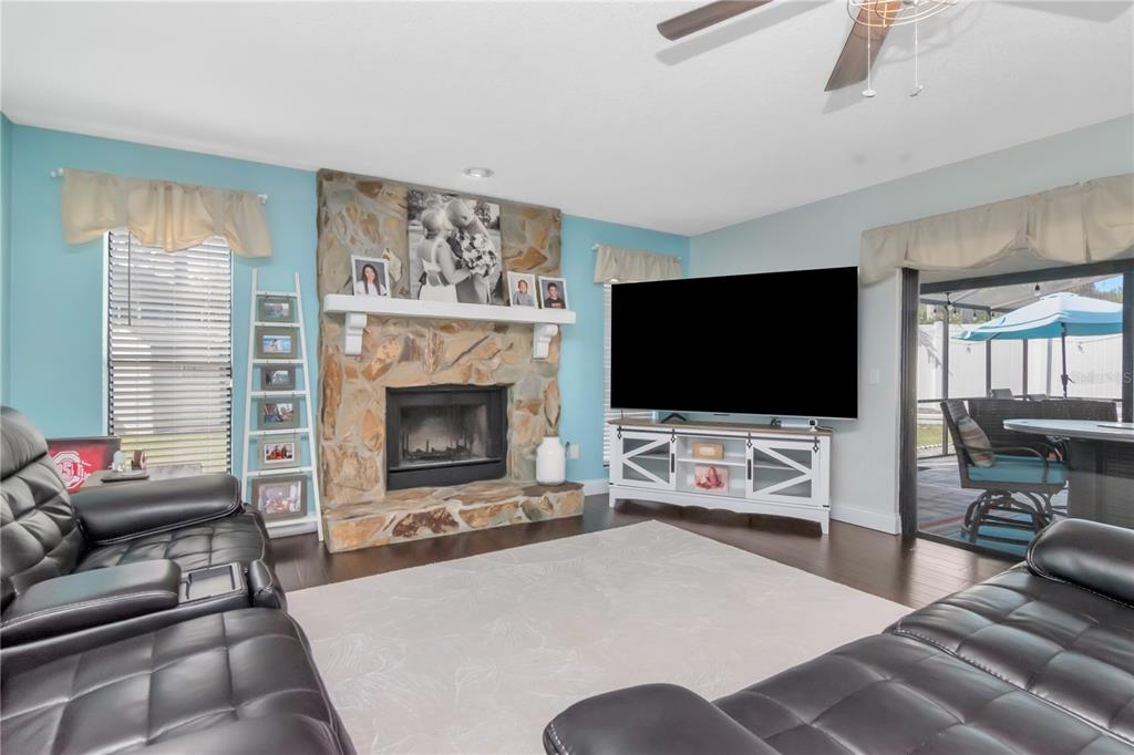 2604 Goldcrest Place Valrico, FL 33596 - Photo 18 of 72 a living room with furniture and a flat screen tv