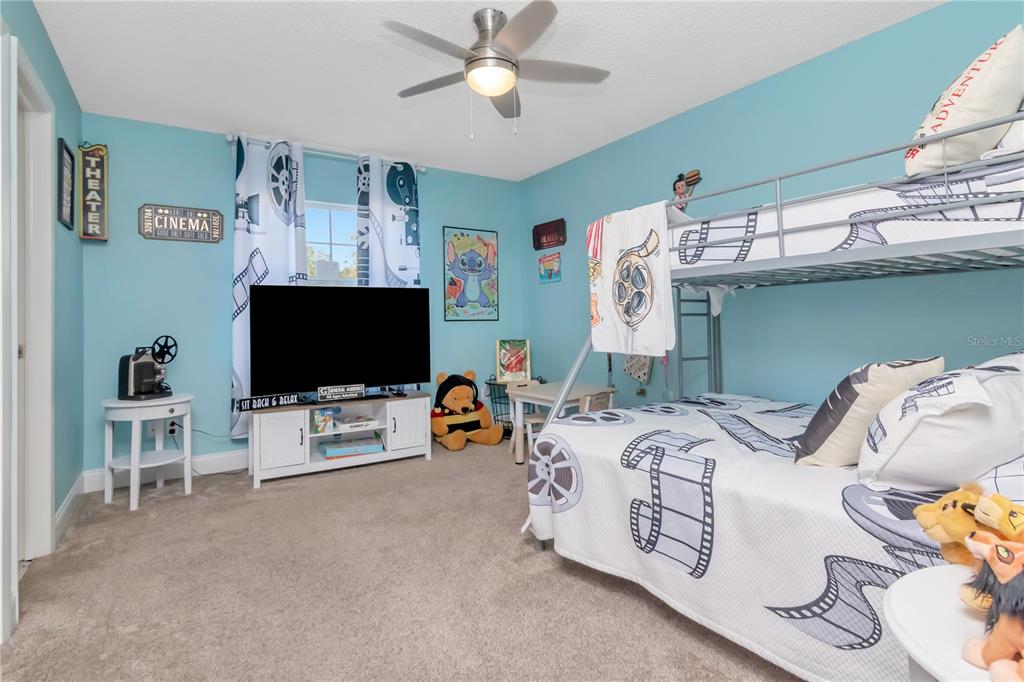 2604 Goldcrest Place Valrico, FL 33596 - Photo 25 of 72 a bedroom with furniture and a flat screen tv