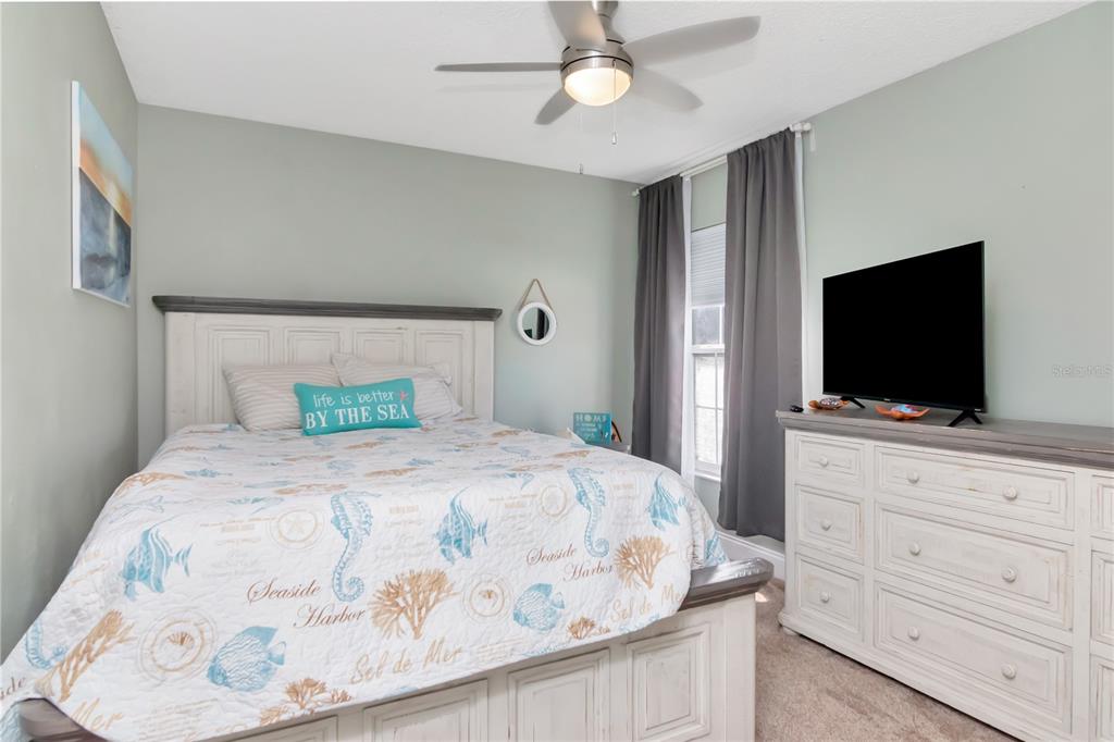 2604 Goldcrest Place Valrico, FL 33596 - Photo 26 of 72 a bedroom with a bed and a flat screen tv in it