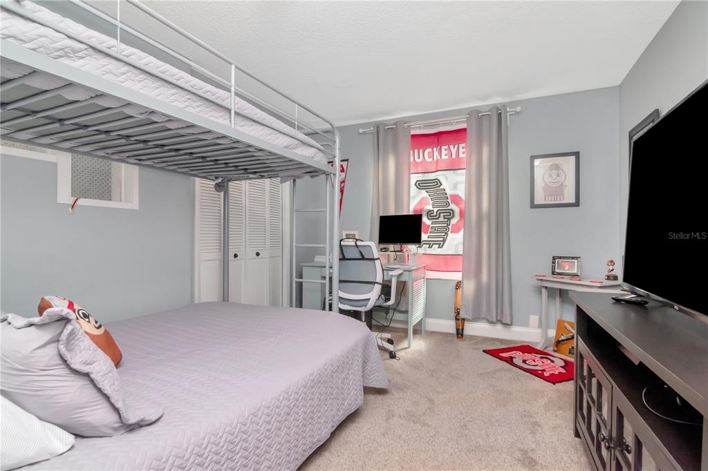 2604 Goldcrest Place Valrico, FL 33596 - Photo 31 of 72 a bedroom with a bed and a flat screen tv