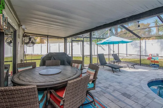 a view of a backyard with plants and outdoor seating