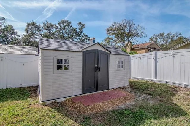 an aerial view of a house with a lake