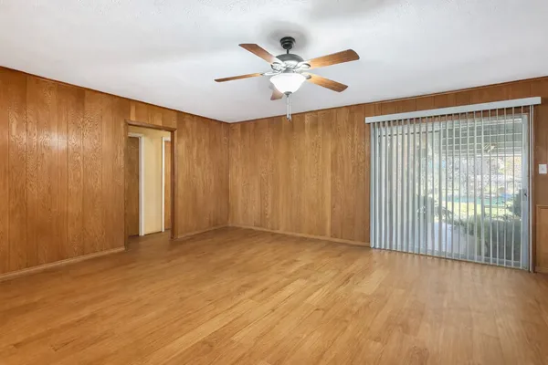 a view of an empty room with wooden floor