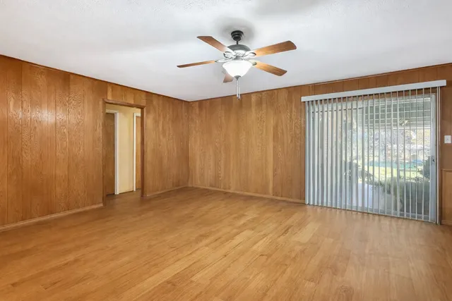 a view of an empty room with wooden floor