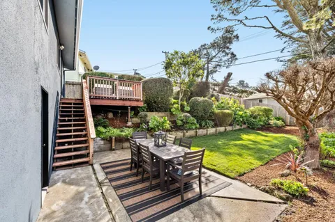 a view of a chairs and table in the balcony