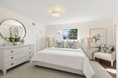 a bedroom with a bed and a mirror