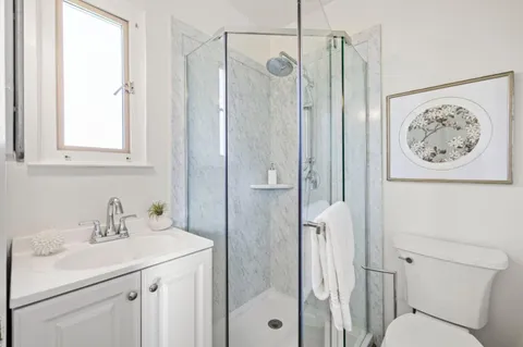 a bathroom with a sink toilet and shower