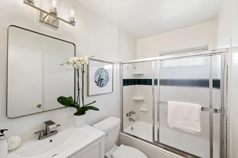 a bathroom with a shower and a sink