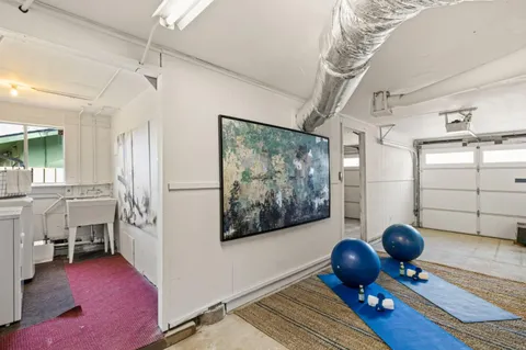 a view of hall way with furniture and chandelier
