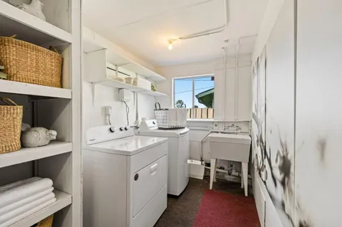 a room with a sink and wooden cabinets
