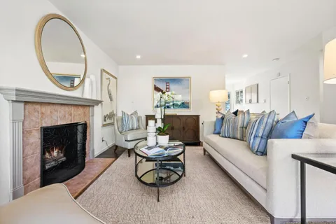 a living room with furniture a window and a fireplace