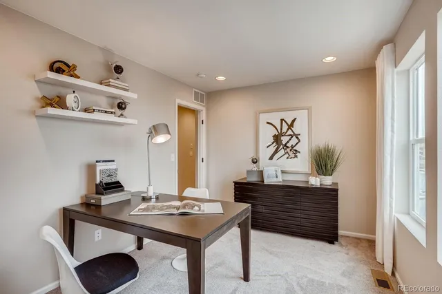 an aerial view of a house with a swimming pool and outdoor seating
