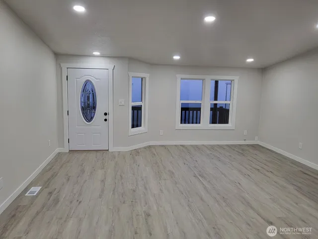 an empty room with wooden floor and painted walls