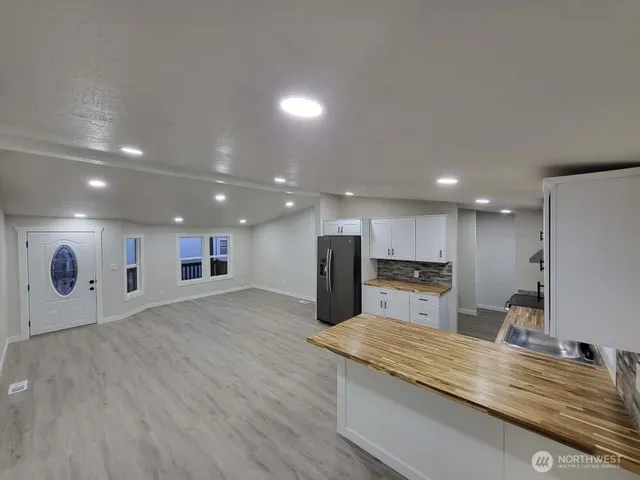 a large kitchen with a large counter top appliances and cabinets