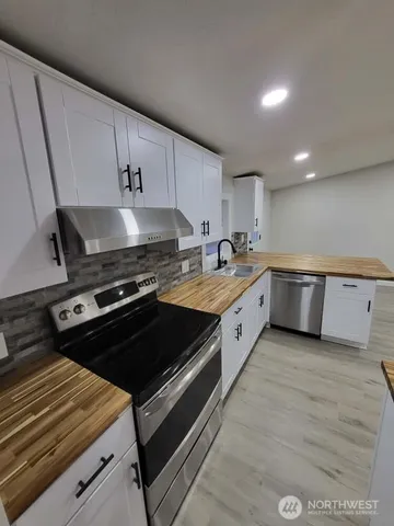 a kitchen with a stove and a sink