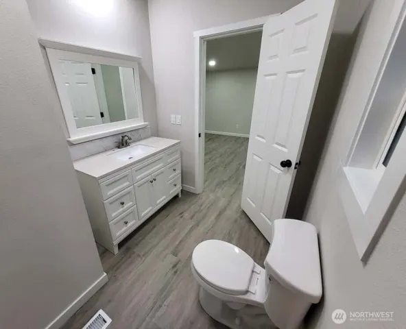 a bathroom with a toilet a sink and a mirror