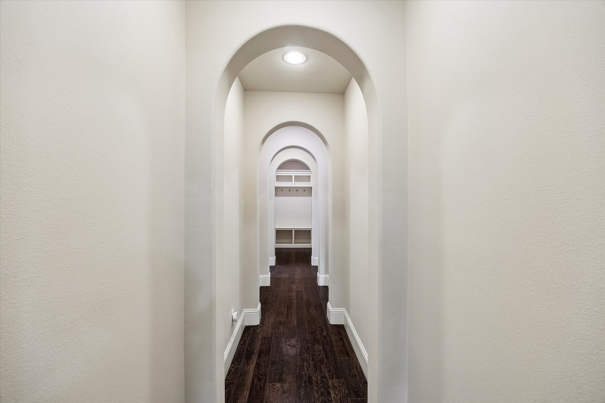 3 Tiburon Court Spring, TX 77389 - Photo 5 of 34 As you lead friends through the home, this hallway always catches their attention. "Look at these arches," you say with a smile. One after another, they create a beautiful architectural rhythm that's impossible to miss. It's a detail many builders skip today, but here it adds warmth, character, and a timeless elegance.