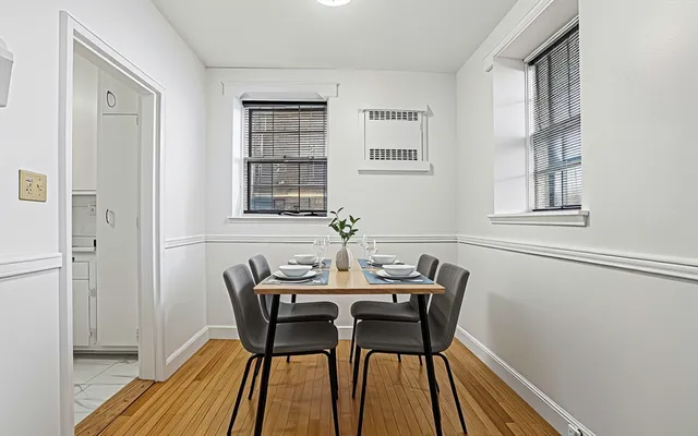 a dining room with wooden floor and breakfast area