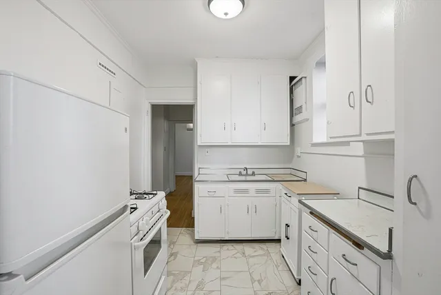 a kitchen with cabinets stainless steel appliances and sink