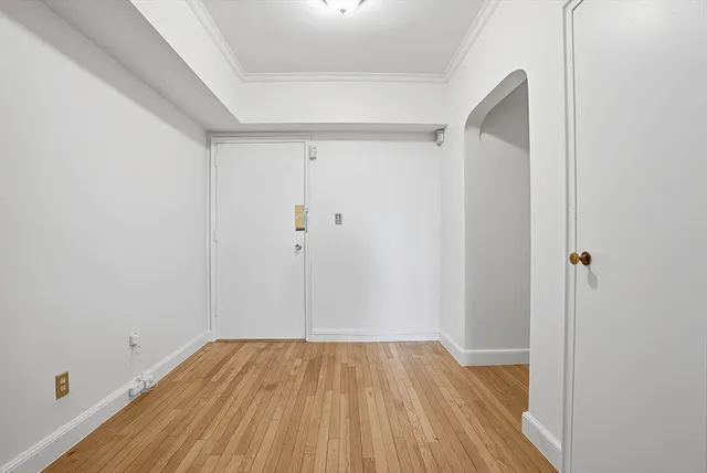 a view of a room with wooden floor