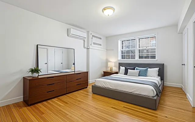 a bedroom with a bed and a mirror