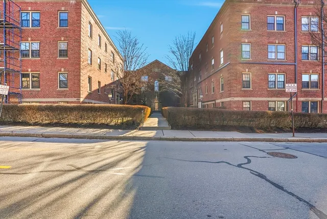 a view of a brick building next to a road