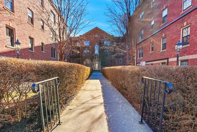 a view of a brick building next to a yard