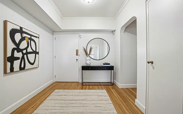 a room with wooden floor and white walls