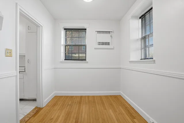 a view of a room with wooden floor and brick walls